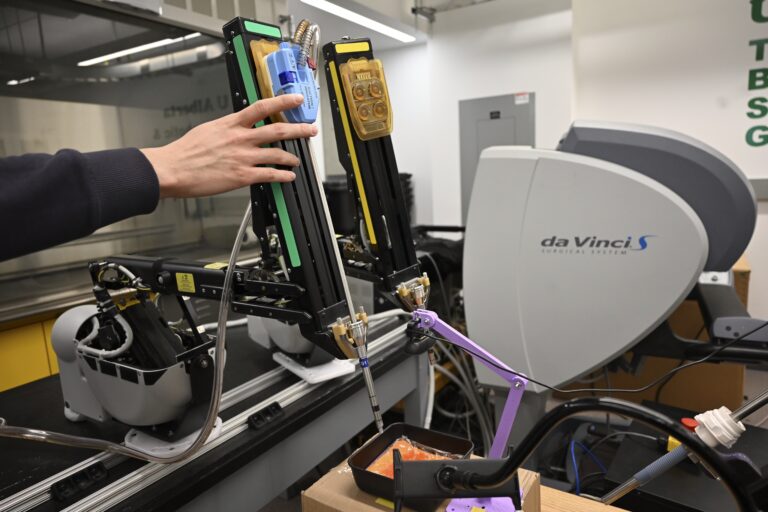 Working with the da Vinci Surgical System's robotic arms.