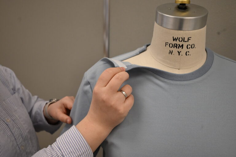 Fitting a prototype garment on a female dress form.